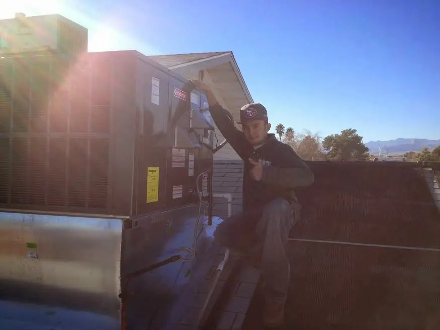 HVAC technician performing Boiler Repair on a rooftop unit in Stony Point